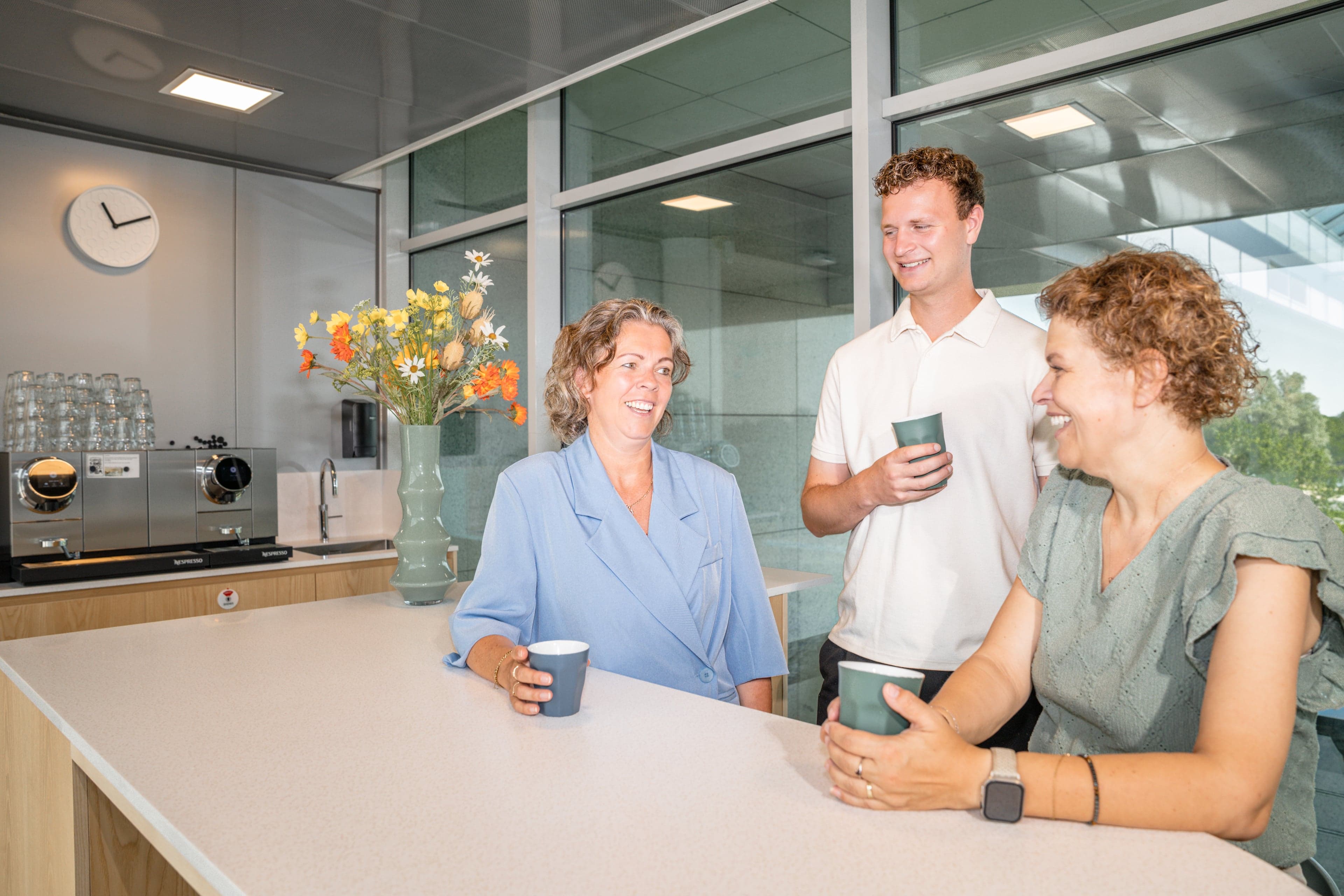 Drie collega's Turien in overleg met koffie